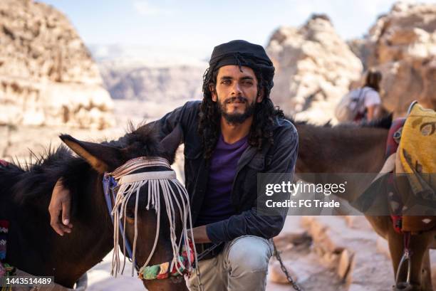 portrait of a young arab man taking care of a horse - gipsy stock pictures, royalty-free photos & images