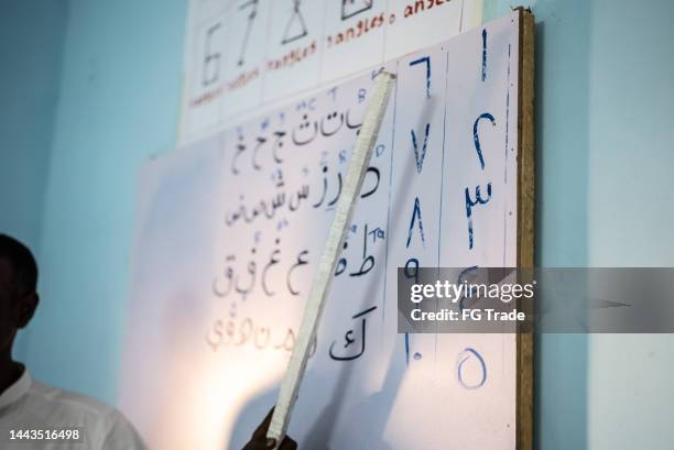 teacher during lecture in the classroom - arabic alphabet stock pictures, royalty-free photos & images