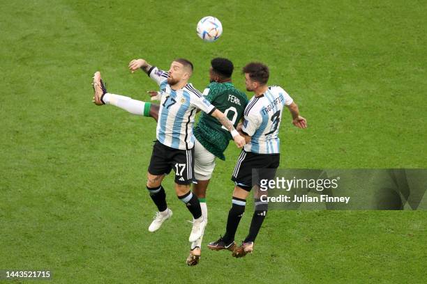 Feras Albrikan of Saudi Arabia competes against Alejandro Gomez and Nicolas Tagliafico of Argentina during the FIFA World Cup Qatar 2022 Group C...