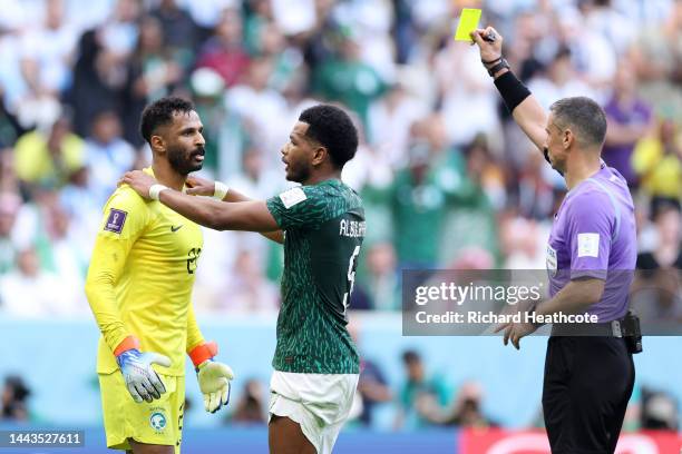 Mohammed Al-Owais of Saudi Arabia is shown a yellow card by referee Slavko Vincic gestures during the FIFA World Cup Qatar 2022 Group C match between...