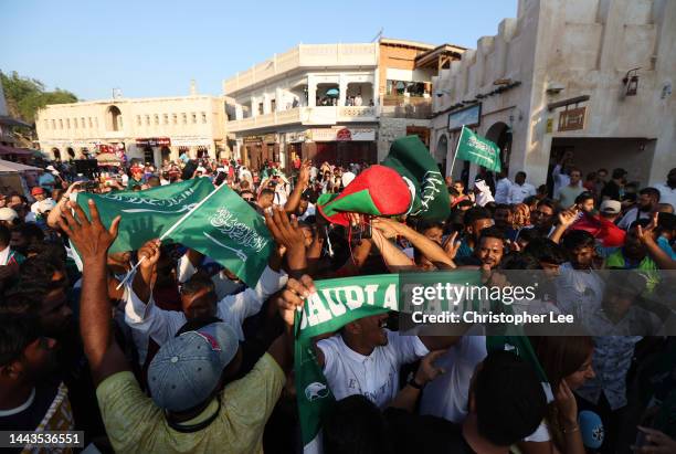 Saudi Arabia fans celebrate their side's victory in the Group C match against Argentina at Souq Waqif in the Mushayrib district on November 22, 2022...