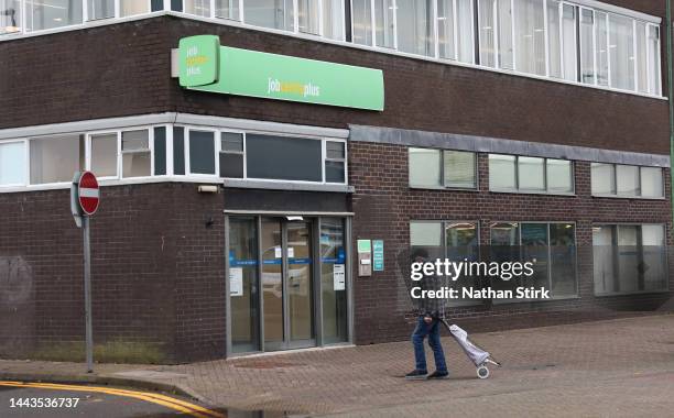 Man walks past a Jobcentre Plus employment office on November 22, 2022 in Stoke-on-Trent, England.