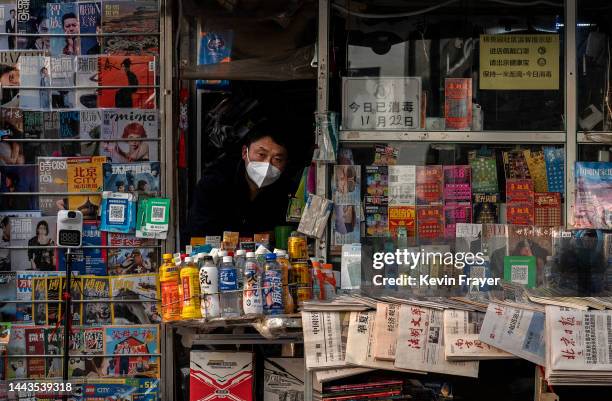 Newspaper and magazine vendor wears a protective mask to protect against the spread of COIVD-19 at he stand on November 22, 2022 in Beijing, China....