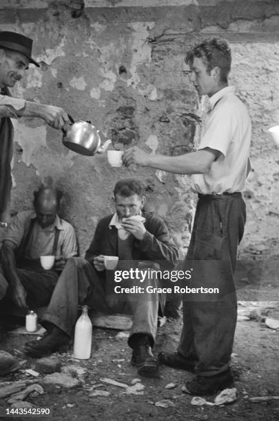 Farm owners and sheep shearers taking a break from their work in Snowdonia. Picture Post - 5377 - Shearing Time In Snowdonia - pub. 11 August, 1951.