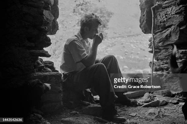 Sheep shearer taking a break from work in Snowdonia. Picture Post - 5377 - Shearing Time In Snowdonia - pub. 11 August, 1951.