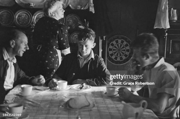 Farm workers take a break with a cup of tea during sheep shearing season in Snowdonia. Picture Post - 5377 - Shearing Time In Snowdonia - pub. 11...