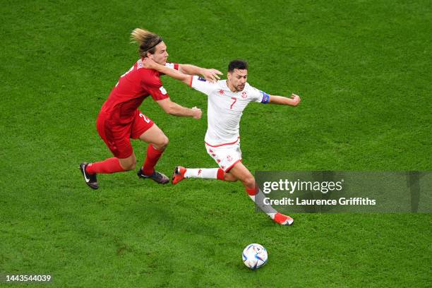 Youssef Msakni of Tunisia battles for possession with Joachim Andersen of Denmark during the FIFA World Cup Qatar 2022 Group D match between Denmark...
