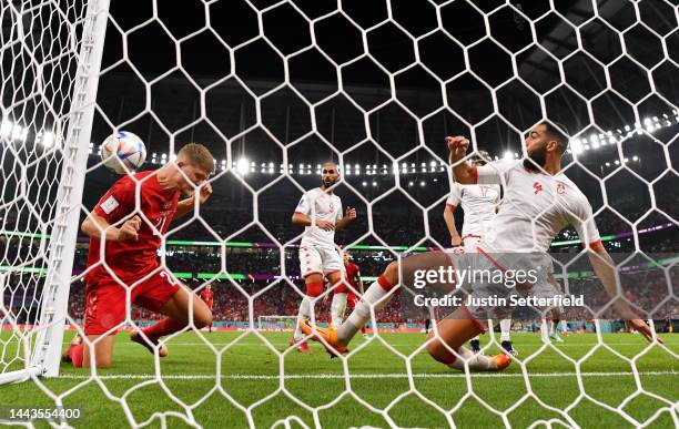 Yassine Meriah of Tunisia defends a header by Andreas Cornelius of Denmark during the FIFA World Cup Qatar 2022 Group D match between Denmark and...