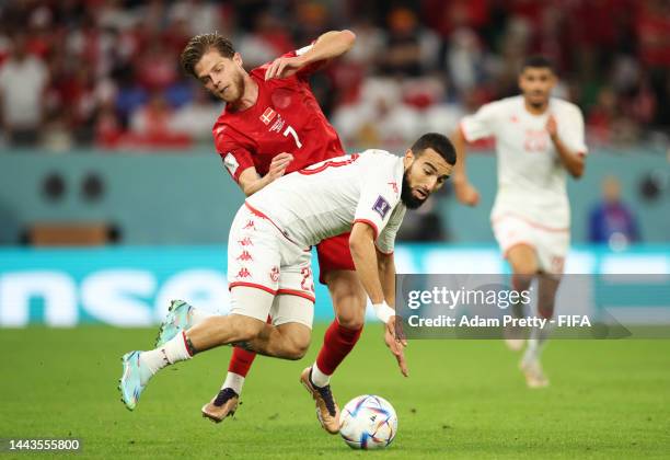 Naim Sliti of Tunisia battles for possession with Mathias Jensen of Denmark during the FIFA World Cup Qatar 2022 Group D match between Denmark and...