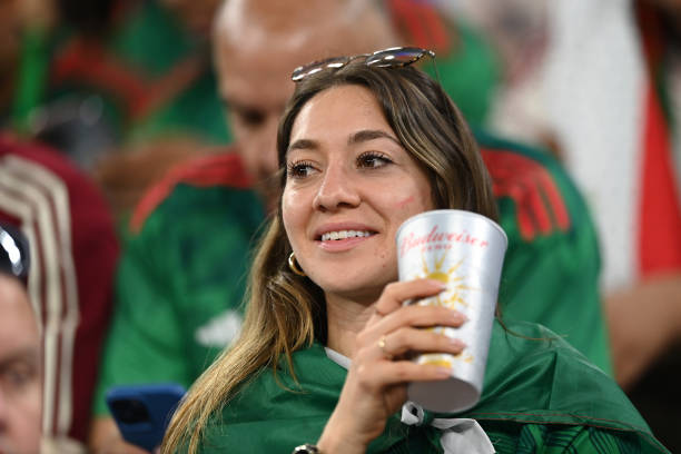 Fan takes a portion from a Budweiser cupful during the FIFA World Cup Qatar 2022 Group C lucifer betwixt Argentina and Saudi Arabia astatine Lusail Stadium on...