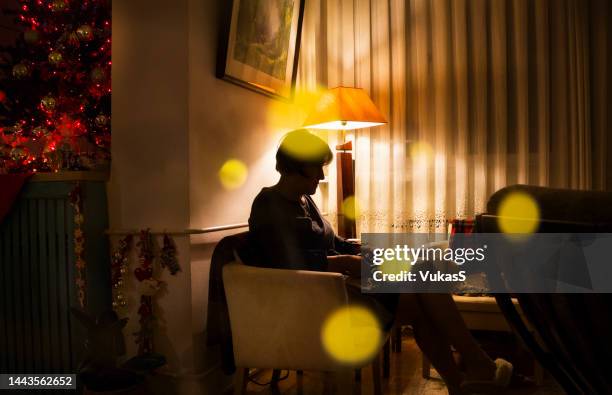 an elderly woman on christmas night - christmas background no people stock pictures, royalty-free photos & images