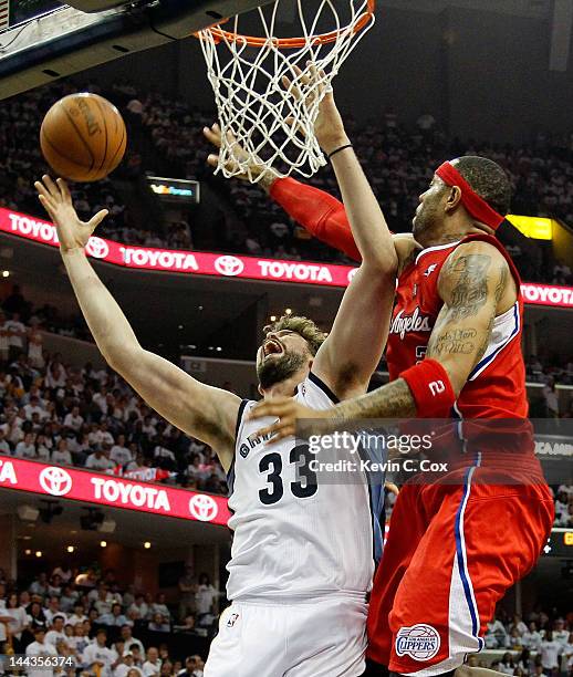 Marc Gasol of the Memphis Grizzlies draws a foul from Kenyon Martin of the Los Angeles Clippers in Game Seven of the Western Conference Quarterfinals...