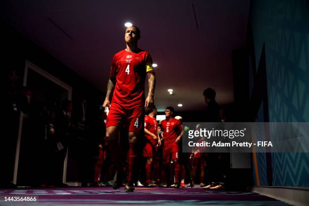 Simon Kjaer of Denmark leads their team out of the tunnel during the FIFA World Cup Qatar 2022 Group D match between Denmark and Tunisia at Education...