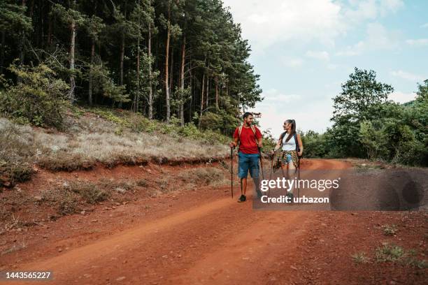 young couple hiking on the trail in the woods - muddy footpath stock pictures, royalty-free photos & images