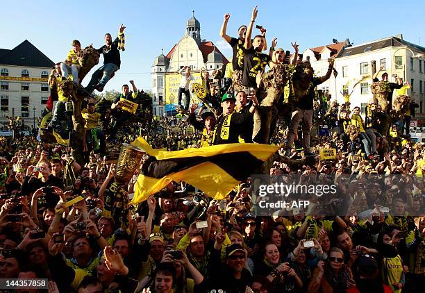 Fans of German soccer champions Borussia Dortmund celebrates the team during a parade after winning the German cup " DFB Pokal " final football...