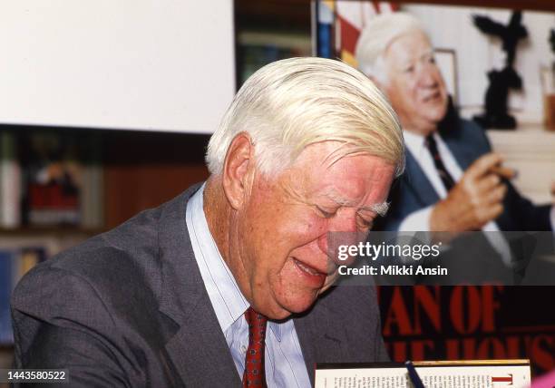 Close-up of former Speaker of the US House of Representatives Thomas Phillip 'Tip' O'Neill signs his autobiography 'Man of the House' at Harvard...