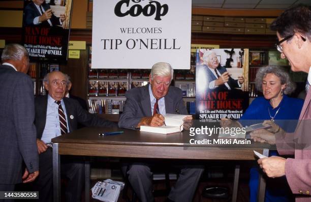 Close-up of former Speaker of the US House of Representatives Thomas Phillip 'Tip' O'Neill signs his autobiography 'Man of the House' at Harvard...