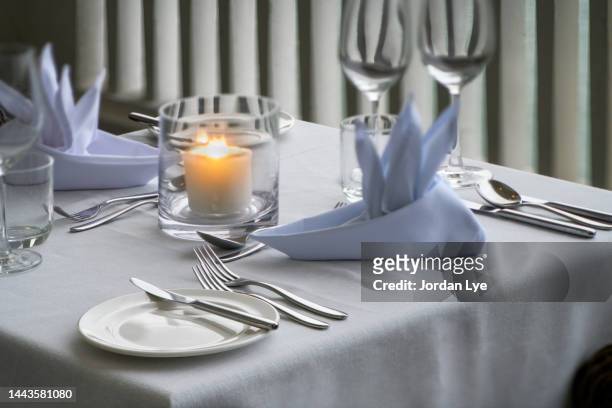 romantic table setting - white candle stock pictures, royalty-free photos & images