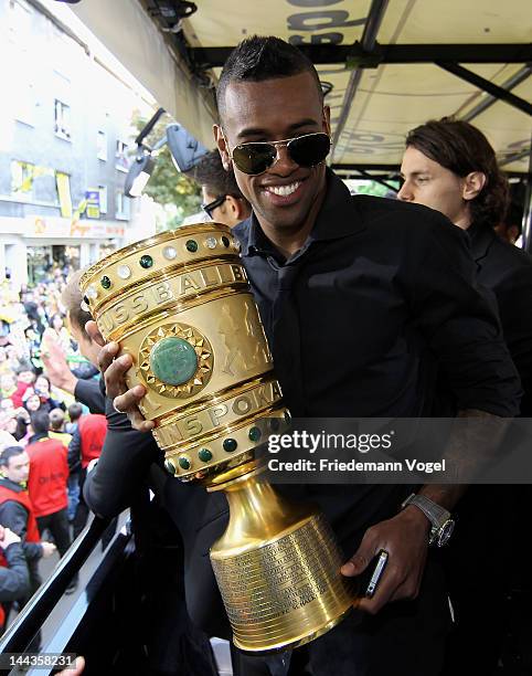 Felipe Santana celebrates during a victory parade on an open top bus after winning the DFB Cup and Bundesliga Trophy, on May 13, 2012 in Dortmund,...