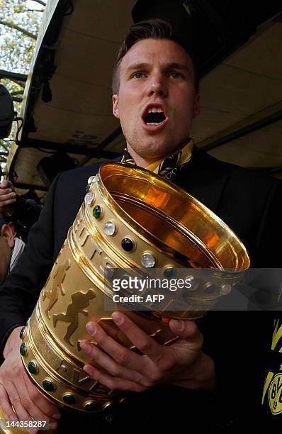 Dortmund's midfielder Kevin Grosskreutz holds the German DFB Cup during a parade after Borussia Dortmund won the German cup " DFB Pokal " final...