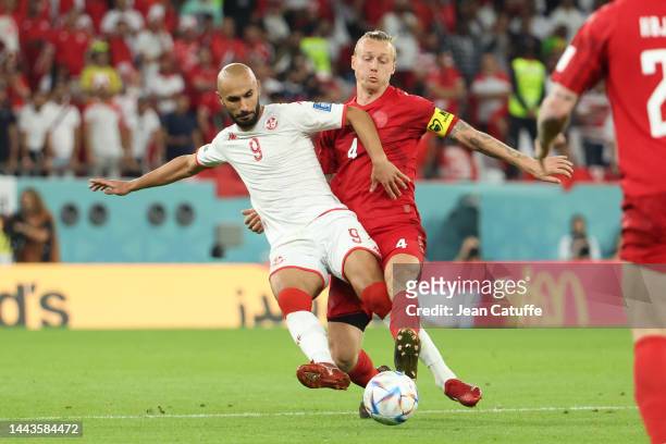 Issam Jebali of Tunisia; Simon Kjaer of Denmark during the FIFA World Cup Qatar 2022 Group D match between Denmark and Tunisia at Education City...