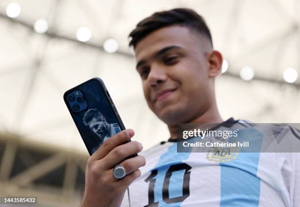 Fan of Argentina with an image of Lionel Messi on the phone case prior to the FIFA World Cup Qatar 2022 Group C match between Argentina and Saudi...