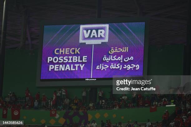 The giant screen indicates a VAR check for a potential penalty during the FIFA World Cup Qatar 2022 Group D match between Denmark and Tunisia at...
