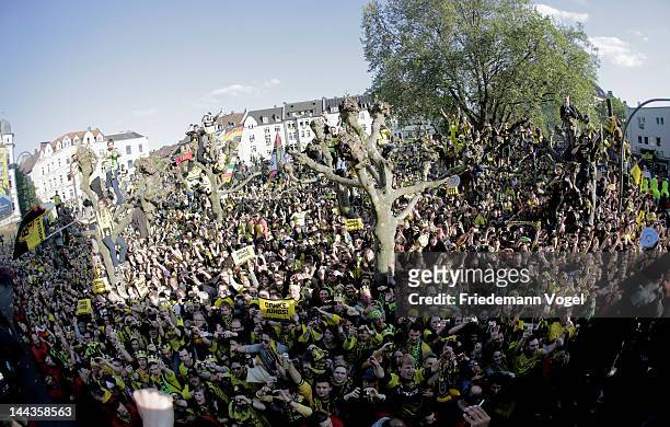 Fans of Dortmund celebrates during a victory parade after winning the DFB Cup and Bundesliga Trophy, on May 13, 2012 in Dortmund, Germany.