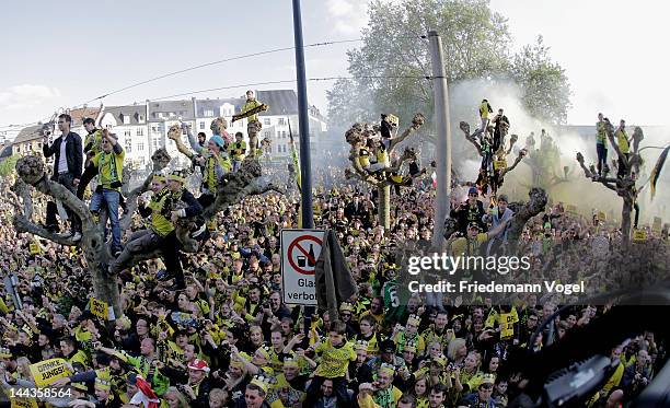 Fans of Dortmund celebrates during a victory parade after winning the DFB Cup and Bundesliga Trophy, on May 13, 2012 in Dortmund, Germany.