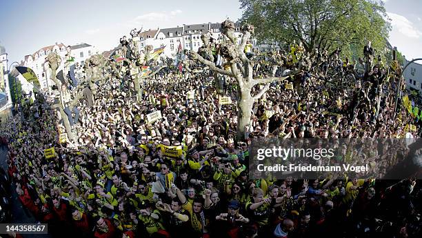 Fans of Dortmund celebrates during a victory parade after winning the DFB Cup and Bundesliga Trophy, on May 13, 2012 in Dortmund, Germany.