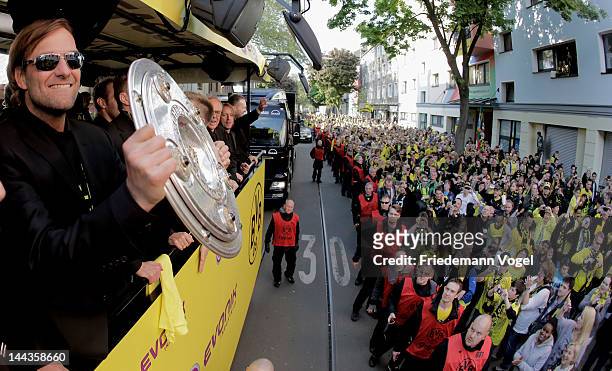 Head coach Juergen Klopp celebrates during a victory parade on an open top bus after winning the DFB Cup and Bundesliga Trophy, on May 13, 2012 in...