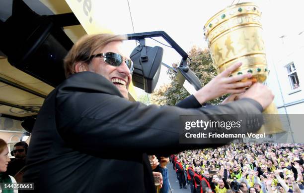 Head coach Juergen Klopp celebrates during a victory parade on an open top bus after winning the DFB Cup and Bundesliga Trophy, on May 13, 2012 in...