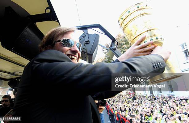 Head coach Juergen Klopp celebrates during a victory parade on an open top bus after winning the DFB Cup and Bundesliga Trophy, on May 13, 2012 in...