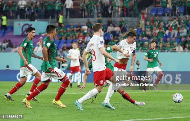 Hector Moreno of Mexico challenges Robert Lewandowski of Poland during the FIFA World Cup Qatar 2022 Group C match between Mexico and Poland at...