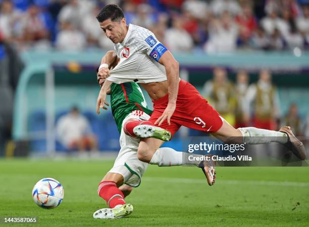 Hector Moreno of Mexico challenges Robert Lewandowski of Poland which leads to a Poland penalty during the FIFA World Cup Qatar 2022 Group C match...