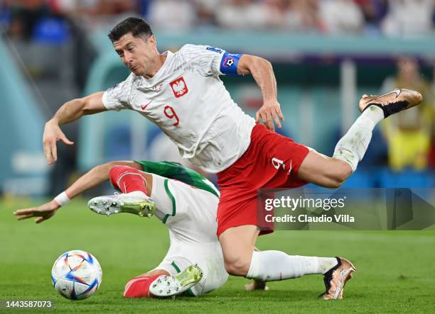 Hector Moreno of Mexico challenges Robert Lewandowski of Poland which leads to a Poland penalty during the FIFA World Cup Qatar 2022 Group C match...