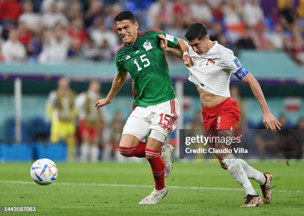 Hector Moreno of Mexico challenges Robert Lewandowski of Poland which leads to a Poland penalty during the FIFA World Cup Qatar 2022 Group C match...