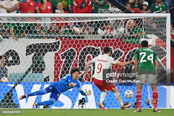 Robert Lewandowski of Poland shoots a penalty which is saved by Guillermo Ochoa of Mexico during the FIFA World Cup Qatar 2022 Group C match between...