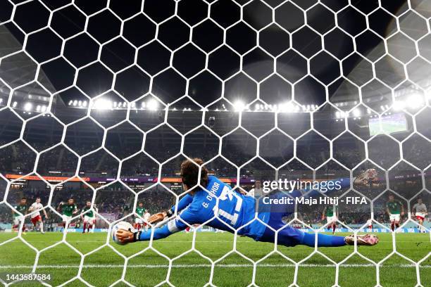 Robert Lewandowski of Poland shoots a penalty which is saved by Guillermo Ochoa of Mexico during the FIFA World Cup Qatar 2022 Group C match between...