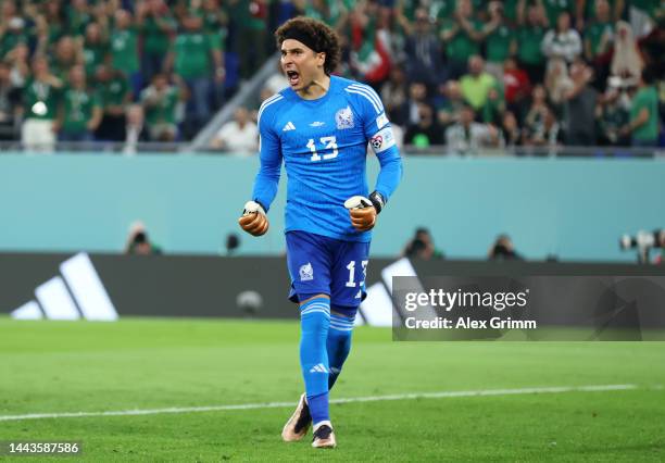Guillermo Ochoa of Mexico reacts after saving a penalty from Robert Lewandowski of Poland during the FIFA World Cup Qatar 2022 Group C match between...