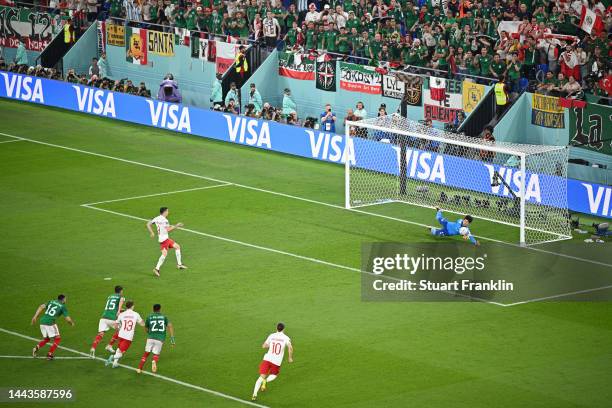 Robert Lewandowski of Poland shoots a penalty which is saved by Guillermo Ochoa of Mexico during the FIFA World Cup Qatar 2022 Group C match between...