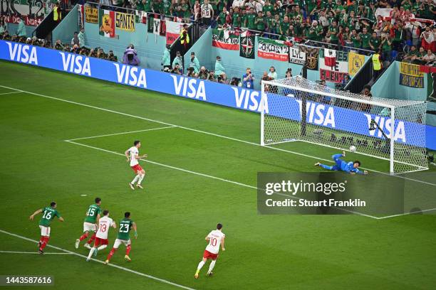 Robert Lewandowski of Poland shoots a penalty which is saved by Guillermo Ochoa of Mexico during the FIFA World Cup Qatar 2022 Group C match between...