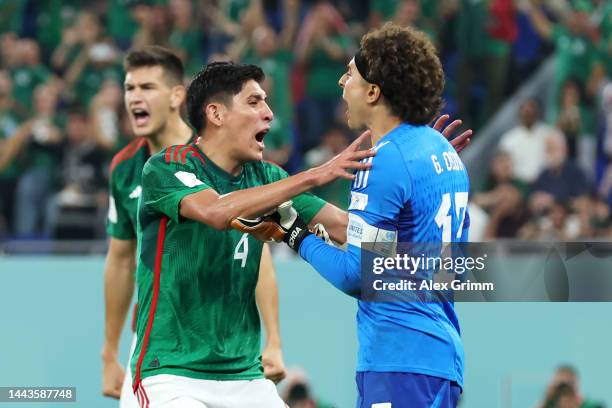 Guillermo Ochoa of Mexico celebrates with Edson Alvarez after saving a penalty from Robert Lewandowski of Poland during the FIFA World Cup Qatar 2022...