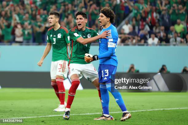 Guillermo Ochoa of Mexico celebrates with Edson Alvarez after saving a penalty from Robert Lewandowski of Poland during the FIFA World Cup Qatar 2022...