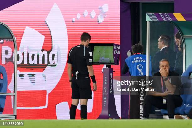 Referee Chris Beath checks the VAR screen before giving a penalty to Poland after a foul during the FIFA World Cup Qatar 2022 Group C match between...