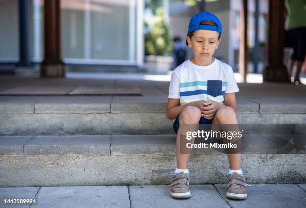 kid sitting on stairs and feeling sad - only boys stock pictures, royalty-free photos & images