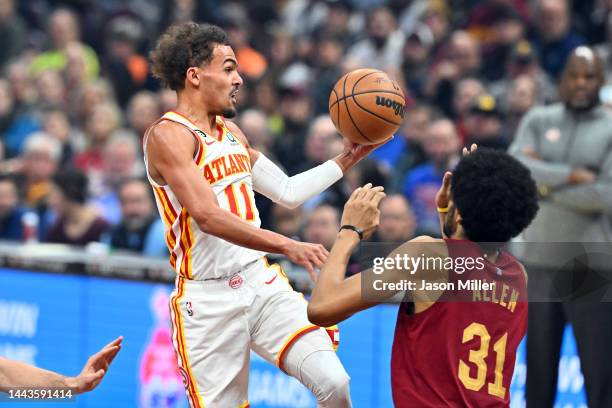 Trae Young of the Atlanta Hawks passes while under pressure from Jarrett Allen of the Cleveland Cavaliers during the first quarter against the...