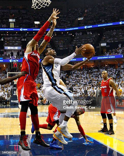 Mike Conley of the Memphis Grizzlies drives under Kenyon Martin of the Los Angeles Clippers in Game Seven of the Western Conference Quarterfinals in...