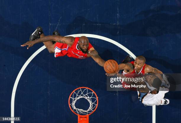 Reggie Evans and Caron Butler of the Los Angeles Clippers reach for the rebound against Rudy Gay of the Memphis Grizzlies in Game Seven of the...