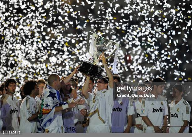 Cristiano Ronaldo of Real Madrid CF holds up the La Liga trophy as he celebrates winning the La Liga title with team-mates after the La Liga match...